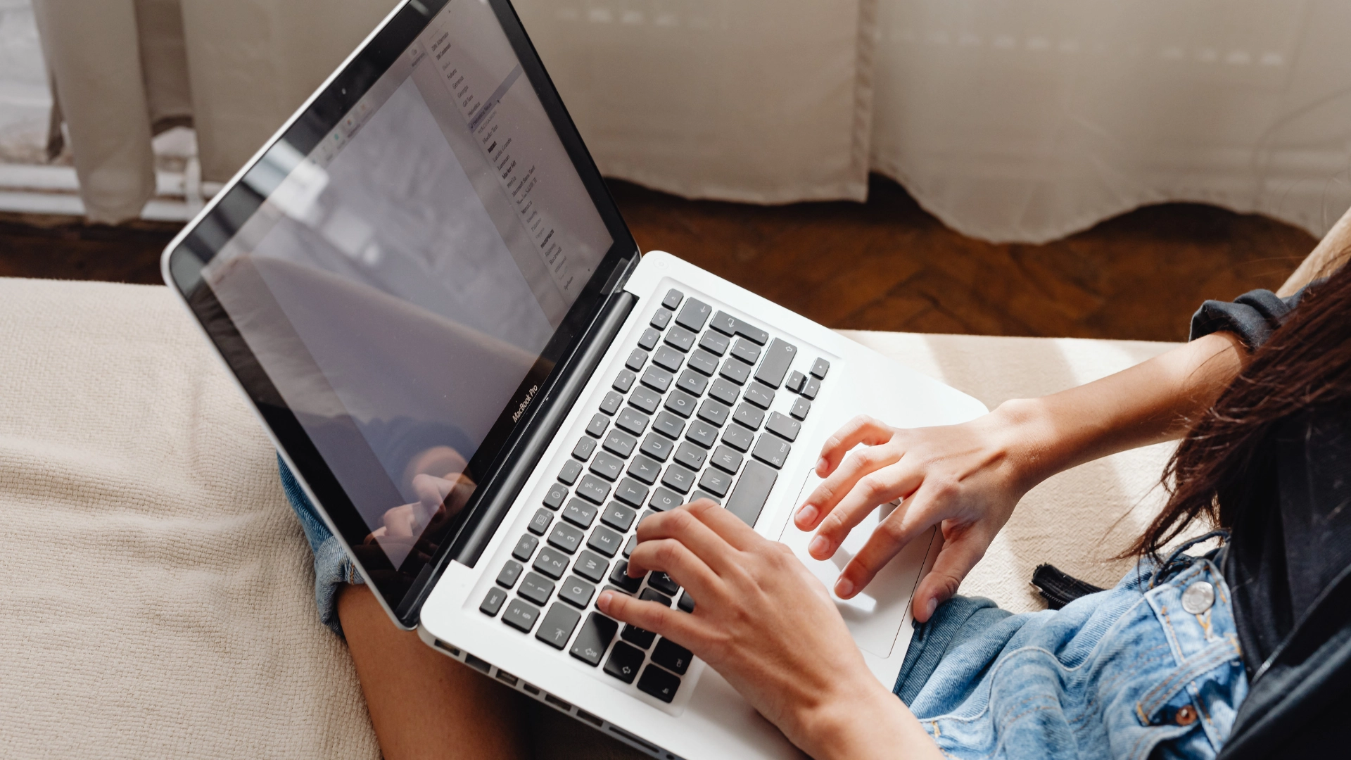 A close up image of a woman working on a laptop computer